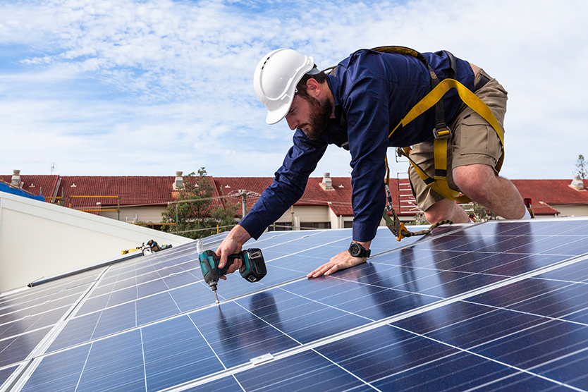 Workers installing PV modules on a rule, symbolising the energy transition platform for buildings
