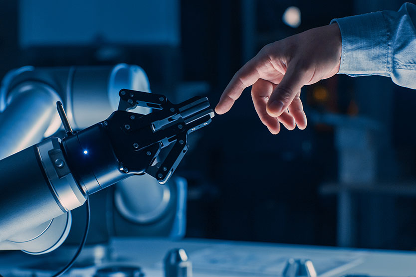 Une main humaine touche la main d'un robot.